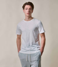 Load image into Gallery viewer, Model wearing Merz B. Schwanen - Good Basics Unisex T-shirt in White.