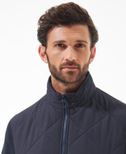 Load image into Gallery viewer, Model wearing Barbour Hybrid Fleece Jacket in Navy.