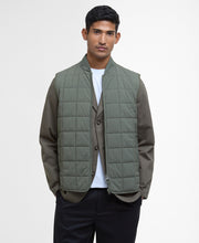 Load image into Gallery viewer, Model wearing Barbour Elmstone Quilted Gilet in Uniform Green.