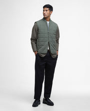 Load image into Gallery viewer, Model wearing Barbour Elmstone Quilted Gilet in Uniform Green.