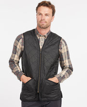 Load image into Gallery viewer, Model wearing Barbour Polarquilt Waistcoat Zip-In Liner in Black.