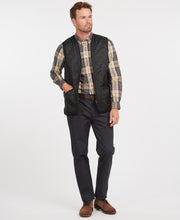 Load image into Gallery viewer, Model wearing Barbour Polarquilt Waistcoat Zip-In Liner in Black.