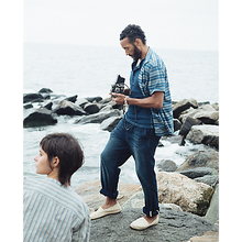 Load image into Gallery viewer, Model wearing RRL - Indigo Striped Jersey Camp Shirt in Indigo Multi.