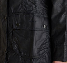 Load image into Gallery viewer, Model wearing Barbour Beadnell wax jacket in navy.