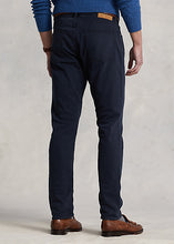 Load image into Gallery viewer, Model wearing POLO Ralph Lauren - Sullivan Slim Knitlike Chino Pant in Avaitor Navy - back.