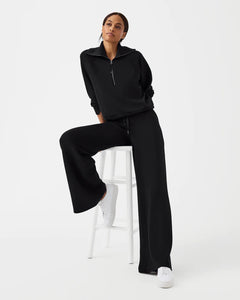 Model wearing Spanx - Air Essentials Wide Leg Pant in Very Black.