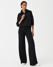 Load image into Gallery viewer, Model wearing Spanx - Air Essentials Wide Leg Pant in Very Black.
