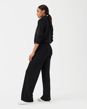 Load image into Gallery viewer, Model wearing Spanx - Air Essentials Wide Leg Pant in Very Black.
