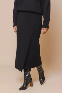 Model wearing Rino & Pelle - Janou Midi Skirt in Black.