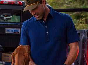 Model wearing  Criquet - Top-Shelf Players Polo in Navy.