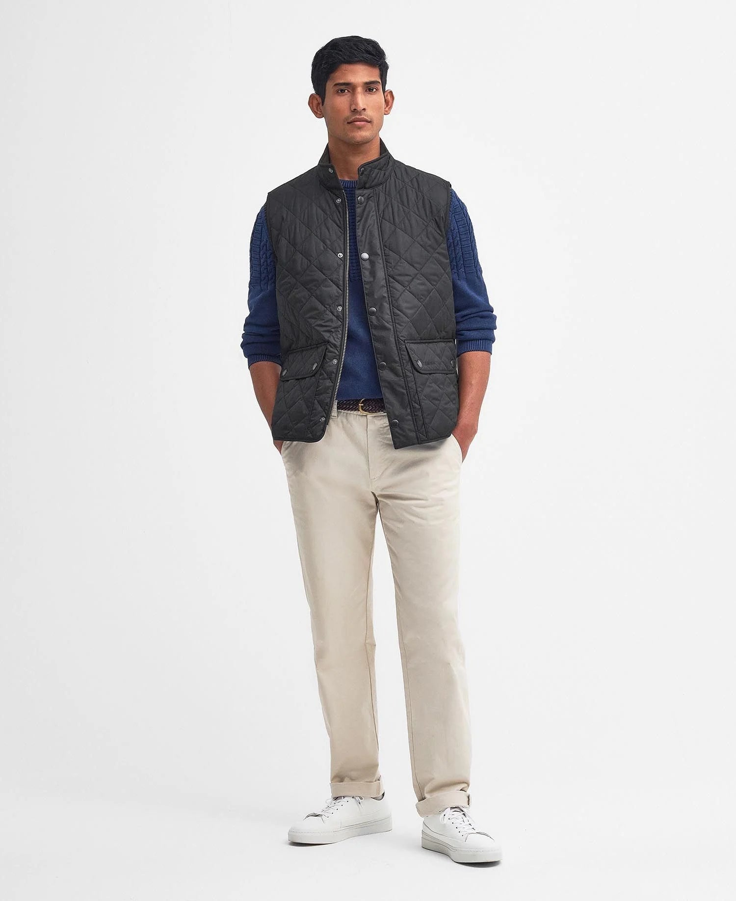 Model wearing Barbour New Lowerdale Quilted Gilet in Black.