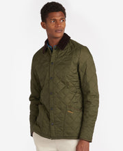 Load image into Gallery viewer, Model wearing Barbour Heritage Liddesdale Quilt in Olive.
