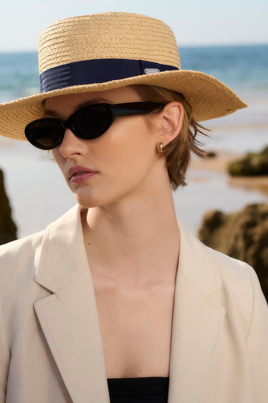 Model wearing Barbour Lily Straw Summer Hat in Natural/Navy.