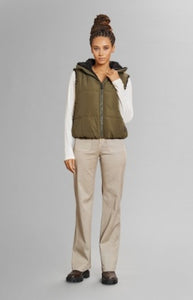 Model wearing Alp N Rock - Sonja Reversible Short Vest in Dark Moss.