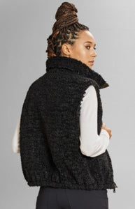 Model wearing Alp N Rock - Sonja Reversible Short Vest in Dark Moss.