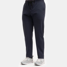 Load image into Gallery viewer, Model wearing TMB - Performance Travel pant in Navy.
