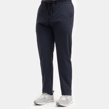 Load image into Gallery viewer, Model wearing TMB - Performance Travel pant in Navy.
