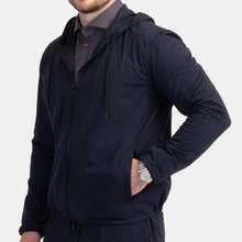 Load image into Gallery viewer, Model wearing TMB - Performance Travel Hoodie in Navy.
