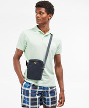 Load image into Gallery viewer, Model wearing Barbour Cascade Flight Bag in Navy.
