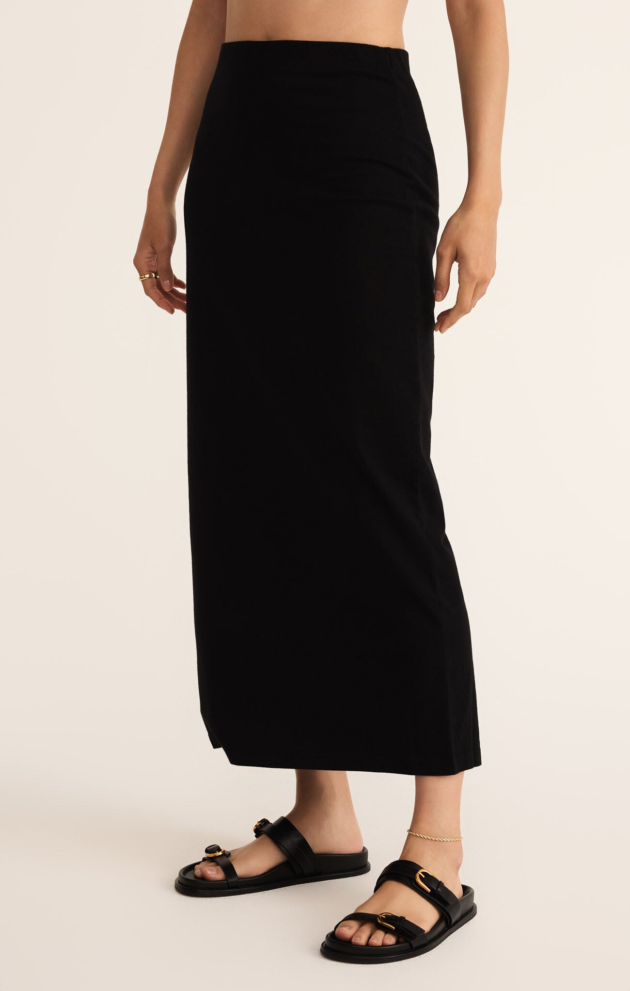 Model wearing ZSupply - Gail Midi Skirt in True Black.