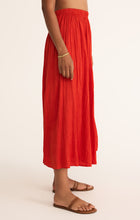 Load image into Gallery viewer, Model wearing ZSupply - Nicoline Crinkle Midi Skirt in Cabana Red.
