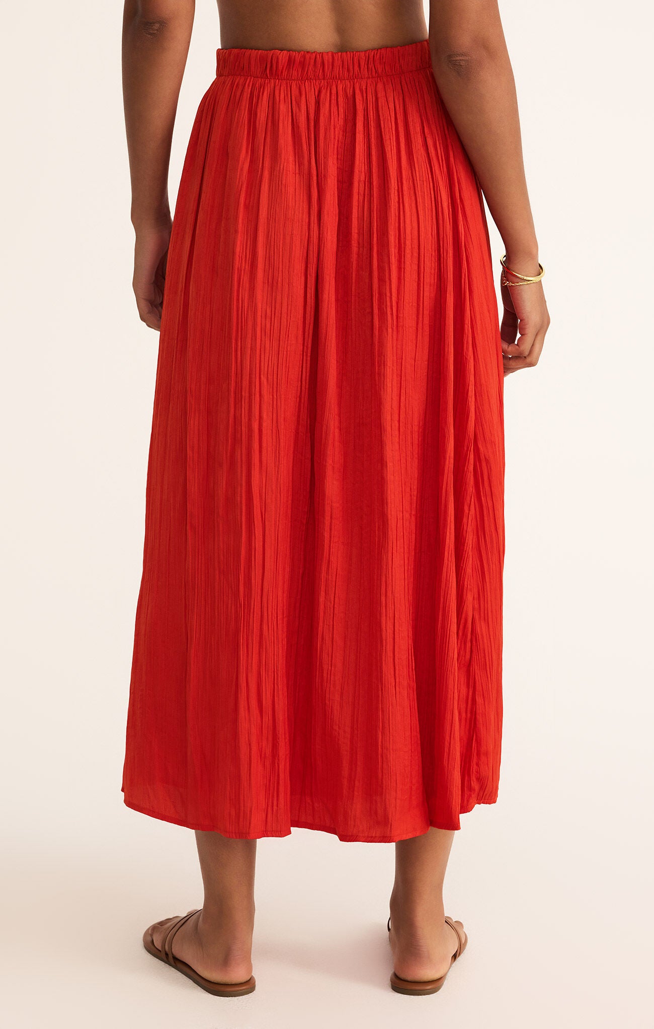 Model wearing ZSupply - Nicoline Crinkle Midi Skirt in Cabana Red - back.