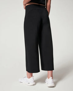 Model wearing Spanx - Air Essentials Cropped Wide Leg Pant in Black - back.