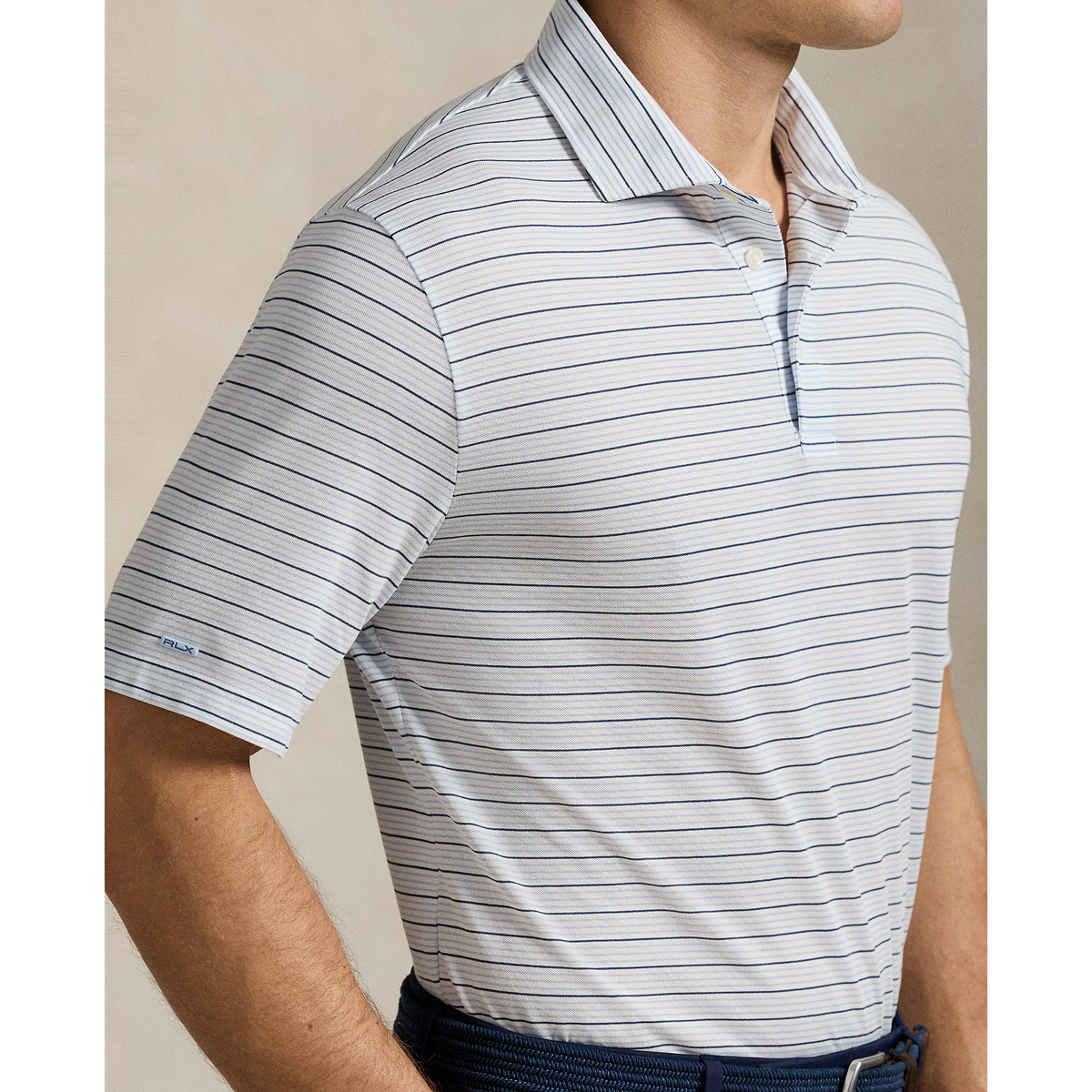 Model wearing RLX - Ralph Lauren Classic Fit Performance Polo Shirt in Office Blue Multi.