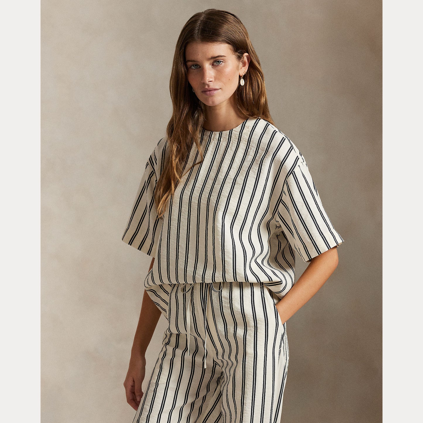 Model wearing Polo Ralph Lauren - Silk Nylon SS Crew Neck Blouse in White/Black Stripe.