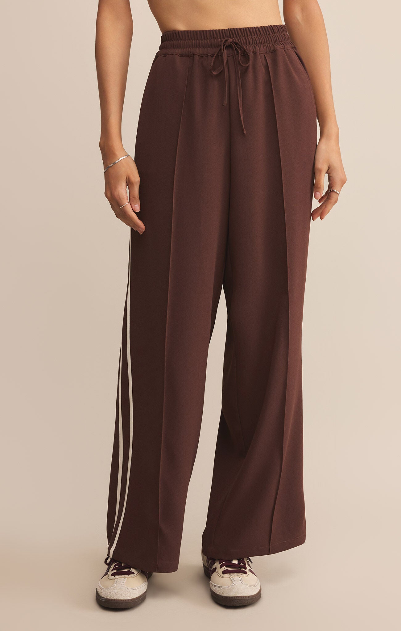 Model wearing ZSupply Saunder Track Pant in Sandalwood.
