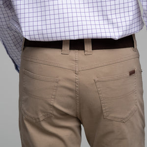 Model wearing Schoffel Men's Canterbury 5 Pocket Jean in Camel back.