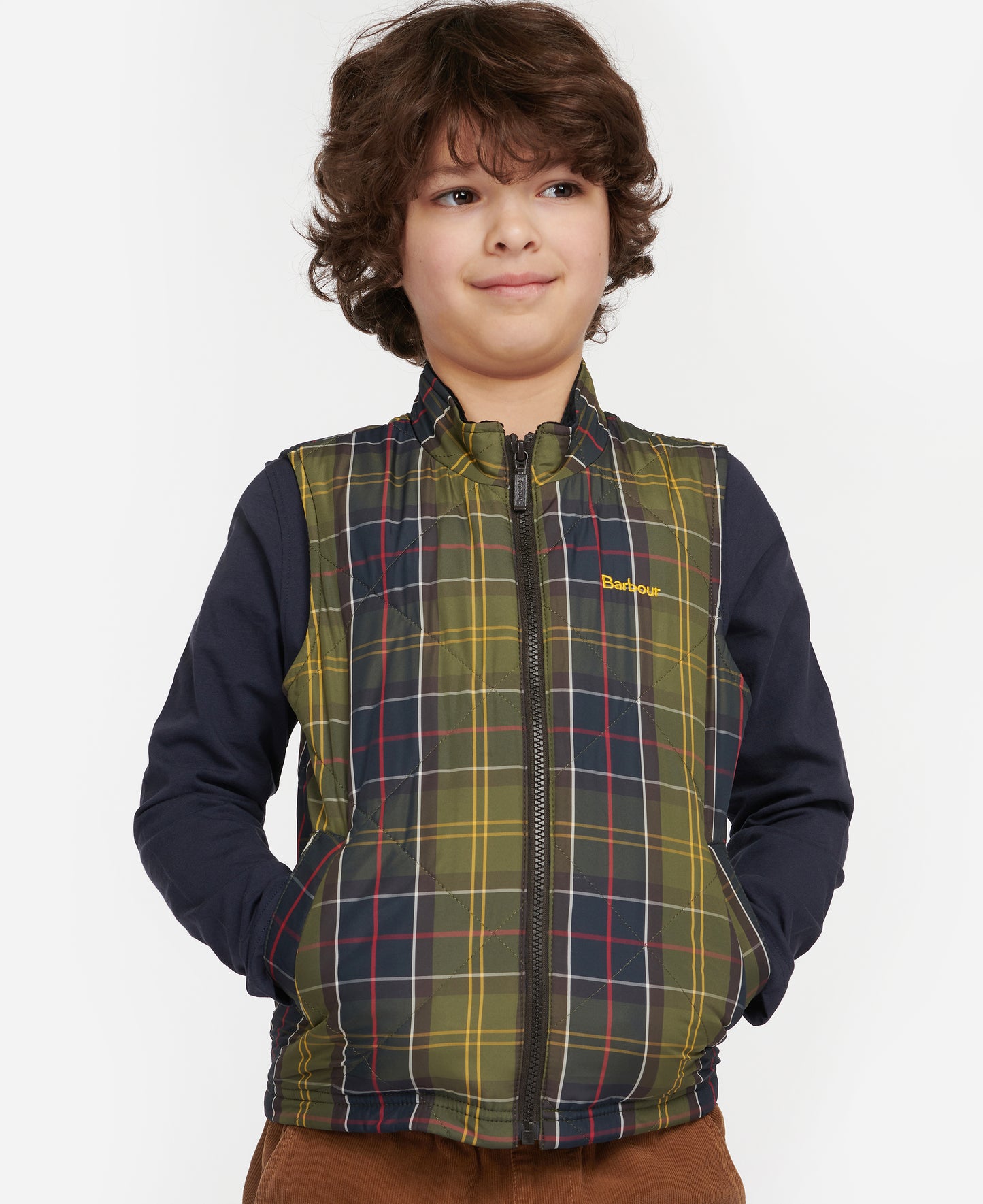 Model wearing Barbour Finn Youth Gilet in Classic Tartan.