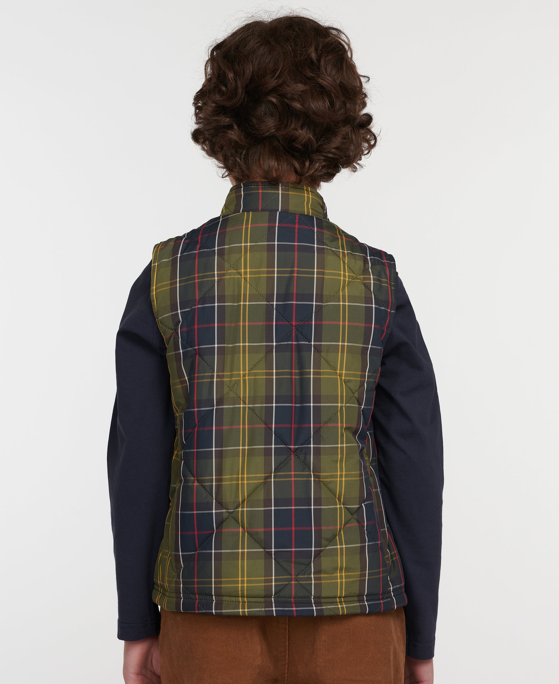 Model wearing Barbour Finn Youth Gilet in Classic Tartan.