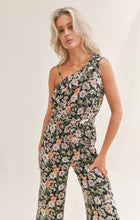 Load image into Gallery viewer, Model wearing Sadie &amp; Sage - Getaway Garden One Shoulder Jumpsuit in Black Multi.
