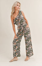 Load image into Gallery viewer, Model wearing Sadie &amp; Sage - Getaway Garden One Shoulder Jumpsuit in Black Multi.
