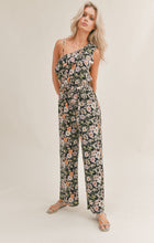 Load image into Gallery viewer, Model wearing Sadie &amp; Sage - Getaway Garden One Shoulder Jumpsuit in Black Multi.
