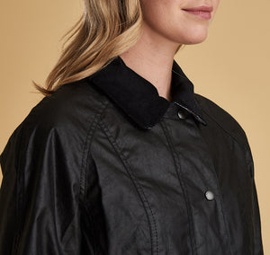 Model wearing Barbour Beadnell wax jacket in black.