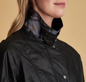 Model wearing Barbour Beadnell wax jacket in black.