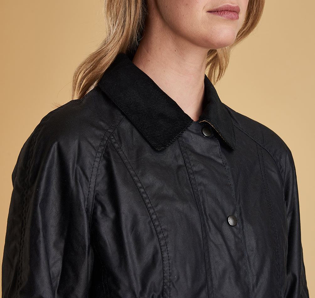 Model wearing Barbour Beadnell wax jacket in navy.