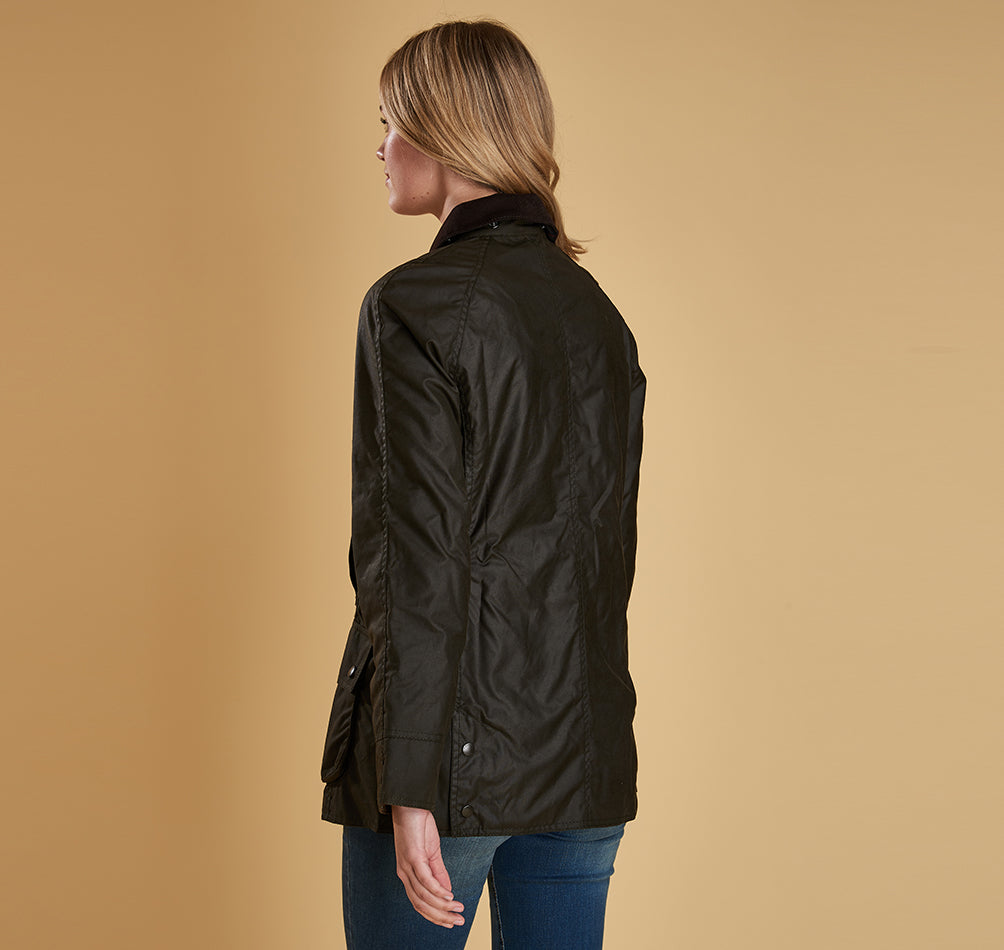 Model wearing Barbour Beadnell wax jacket in olive.