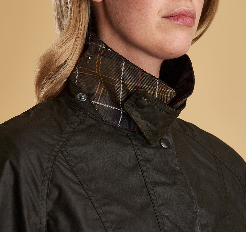 Model wearing Barbour Beadnell wax jacket in olive.