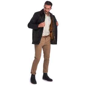 Model wearing Jacket with Barbour Warm Pile Waistcoat Zip-In Liner in brown.