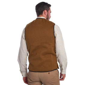 Back of Model wearing Barbour Warm Pile Waistcoat Zip-In Liner in brown.