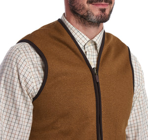 Model wearing Barbour Warm Pile Waistcoat Zip-In Liner in brown.
