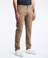Load image into Gallery viewer, Model wearing Public Rec Workday Pant straight leg in dark khaki.
