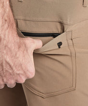 Load image into Gallery viewer, Model wearing Public Rec Workday Pant straight leg in dark khaki.
