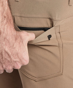 Model wearing Public Rec Workday Pant straight leg in dark khaki.