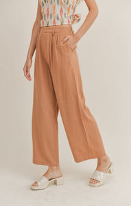 Model wearing Sadie & Sage - Out West Linen Pants in Tan.