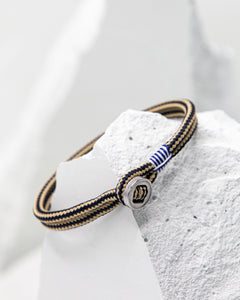 Pig & Hen Don Dino bracelet in navy / sand with silver ring.