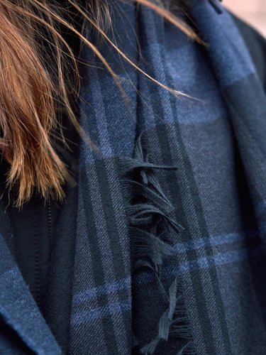 Model wearing Begg & Co - Vale Blackadder Lambswool Cashmere Scarf in Black.